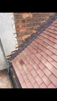 Red tiling work carried out on a roof. Taken from roof level.