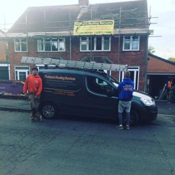 An image of the previous company van parked out the front of a property where work is being carried out. Two staff members are stood in front of the van.