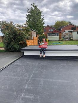 Girl holding Pedmore Roofing poster