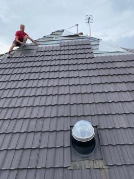 Employee working on a tiled roof